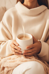 woman in soft knitwear, enjoying a mug of hot cocoa in a cozy setting сreated with Generative Ai
