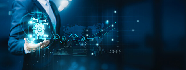 Businessman hand-holding machine learning icons with seamless network connections. Accelerating the...