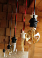 Vintage light bulbs suspended from a wire. Hanging retro incandescent lamps.  closeup of photo             - 789342563