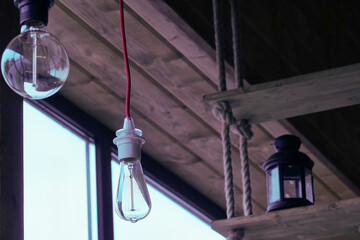 Vintage light bulbs suspended from a wire. Hanging retro incandescent lamps.  closeup of photo           - 789342929