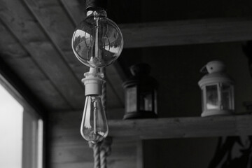 Vintage light bulbs suspended from a wire. Hanging retro incandescent lamps. The view from the window. closeup of photo              