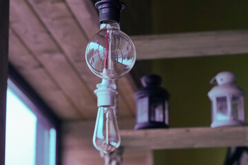 Vintage light bulbs suspended from a wire. Hanging retro incandescent lamps. closeup of photo
- 789342943