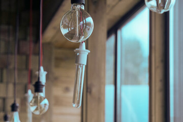 Vintage light bulbs suspended from a wire. Hanging retro incandescent lamps.  closeup of photo     ...