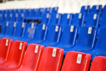 Empty seats in a stadium, close-up. Blue and red seats 