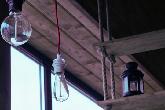 Vintage light bulbs suspended from a wire. Hanging retro incandescent lamps.  closeup of photo          