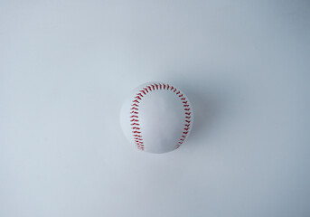 White and red colored baseball sport ball object photography isolated on horizontal white studio background from top angle.