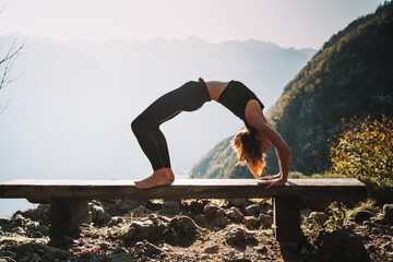 Yoga on nature. Young woman is practicing yoga in mountains - 789344963