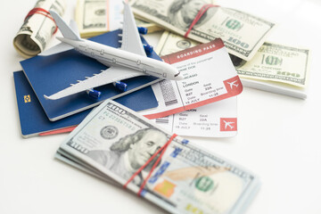 Airplane and money. Plane on the background of USA dollars. The cost of travel, air tickets and flights, financial expenses for vacation.
