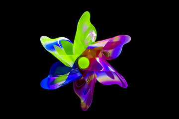 A front view of a regular toy pinwheel windmills with six differently psychedelic colored vanes rotating on a stick on a black screen background, slow shutter speed motion blur