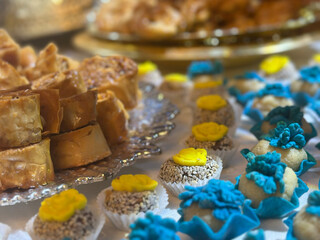 Traditional sweets cookie on holiday of henna. Arabic and Jewish sweets with nuts and sesame. Many colorful cookie on table. gold traditional utensils.