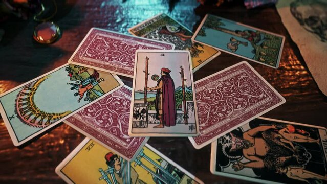 Munich, Germany - May 1, 2013. Psychic using the magic Tarot Card Deck for fortune telling. Oracle predicting fortune with magical Two Of Wands from the deck. Fortune forecasting with magic deck.