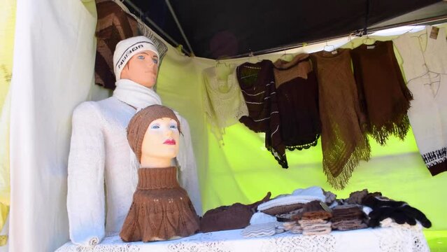 Handmade alpaca crafts on the market in the Andes of Peru and Bolivia. the Andes mountain range illuminated with natural light