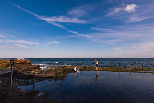Children swimming in the Bogey Hole, historic man-made rock pool in Newcastle NSW