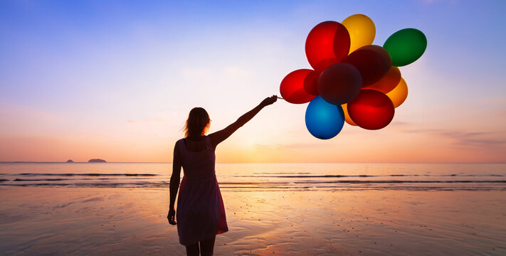 inspiration, imagination and creativity, colors, silhouette woman with multicolored balloons at sunset beach