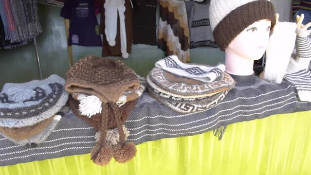 Handmade alpaca crafts on the market in the Andes of Peru and Bolivia. the Andes mountain range illuminated with natural light