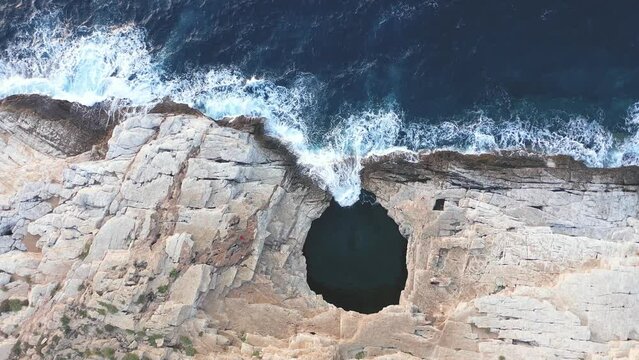 Slow motion aerial view of Giola lagoon, natural sea pool Thassos island, Greece