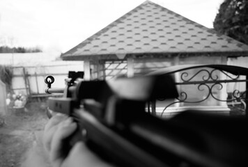 Automatic gun weapon at shooting range backdrop