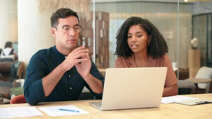 Two busy business people man and woman working on computer discussing online project at work. Diverse professional workers team talking on financial technology or marketing data using laptop in office - Powered by Adobe