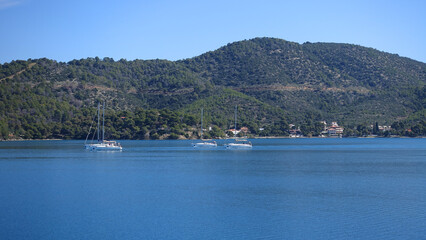 Sail boats near picturesque village of Poros island, Saronic Gulf, Greece