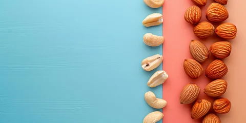Fotobehang Assorted almonds and walnuts on vibrant blue and pink background with ample space for text © SHOTPRIME STUDIO