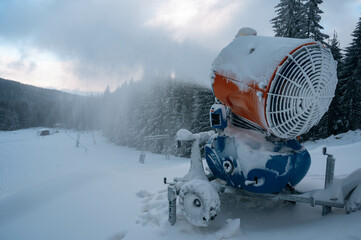 Snow cannon in winter mountains.