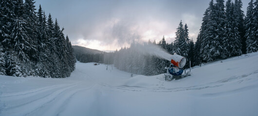Snow cannon in winter mountains.