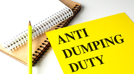 ANTI DUMPING DUTY text on yellow paper with notebooks