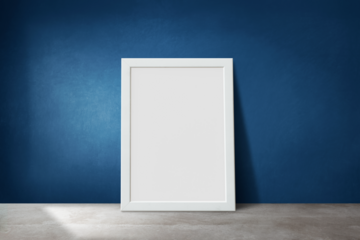 White picture frame mockup leaning against a blue wall