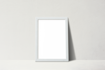 White picture frame leaning against on a beige wall