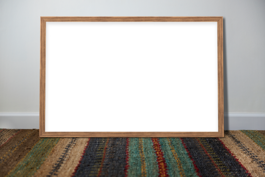 Wooden picture frame mockup leaning against a gray wall