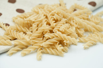 Close up of raw macaroni pasta isolated on white background.