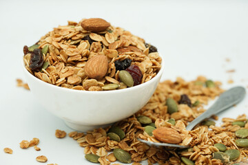 Close up of Homemade granola with mix nuts in a white bowl. Healthy snack and breakfast.