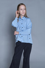 Youngster making a fashion statement in a poised pose. Ideal for illustrating independence and...