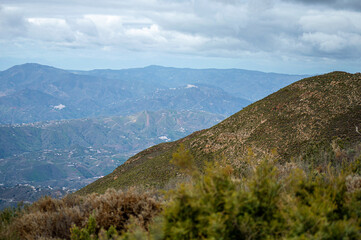 Fototapeta na wymiar Panoramic view from hiking trail to Maroma peak in thunderstorm day, Sierra Tejeda, Spain 