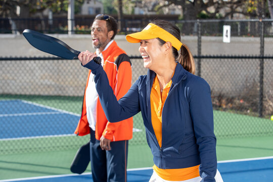 Pickleball players working together as a team. The fun and popular sport is a great way to exercise outside and work together as partners in the competition.