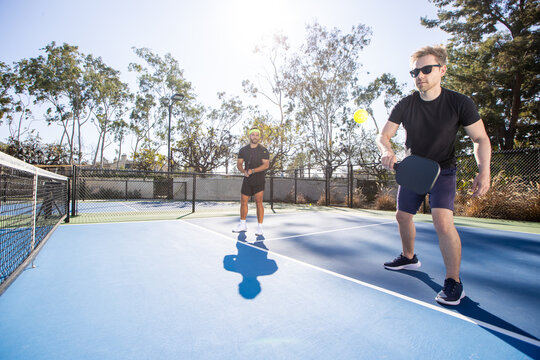 Pickleball players working together as a team. The fun and popular sport is a great way to exercise outside and work together as partners in the competition.