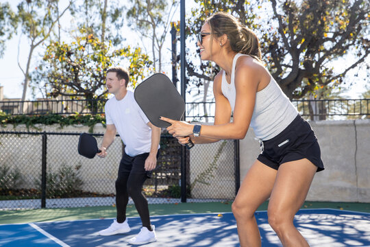 Pickleball players working together as a team. The fun and popular sport is a great way to exercise outside and work together as partners in the competition.