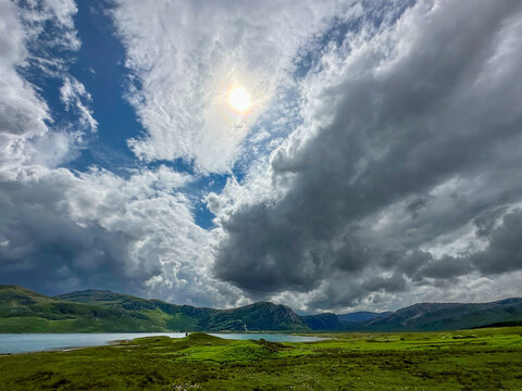 View of storm clouds with the sun shining through, over Loch Eriboll, Scotland