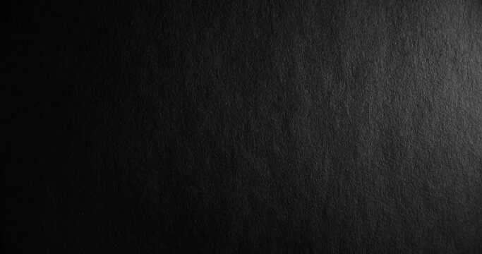 Black rough paper surface, slow moving. Use for background and texture.