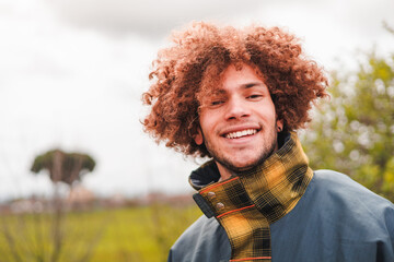 Carefree z generation male with curly hair. Headshot.