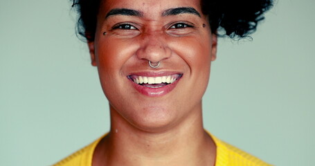 One happy young African American woman close-up face smiling and laughs, authentic real life expression of a Brazilian person reacting to funny comment - obrazy, fototapety, plakaty