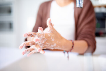 Person, washing hands and soap with cleaning for hygiene, protect from bacteria or germs with...