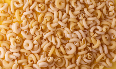 Yellow Pasta insalatonde close-up. Top view. Flatlay. Texture