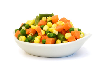 Fresh mixed vegetables in bowl on white. Golden mix.