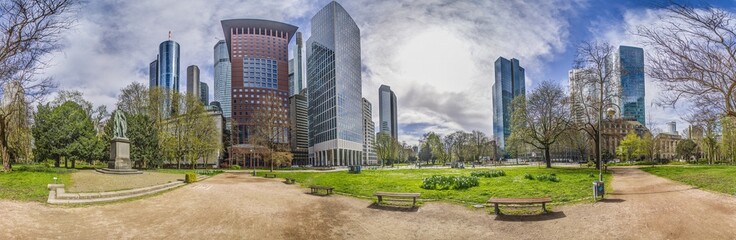 Panoramic picture of the Frankfurt skyline in front of blue sky with light clouds