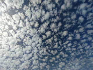 many small clouds in the blue sky