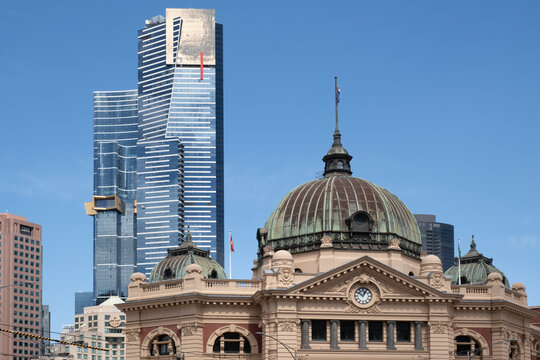 Flinders Street Train Station with its prominent dome and with modern Eureka Tower with observation skydeck in the background