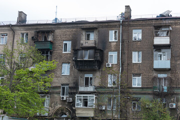 A Russian missile hit a residential building in the city of Dnepr, Ukraine. Damaged apartment building after a massive missile attack on 04/19/24. Scars of war. Consequences of the attack - obrazy, fototapety, plakaty