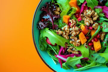 Rolgordijnen Colorful Salad with Walnuts, Pomegranate, and Assorted Vegetables in Bowl on Vibrant Orange Background © SHOTPRIME STUDIO