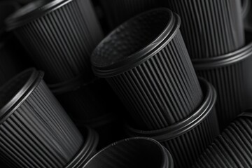A close up of a bunch of black cups. Perfect for kitchenware advertisements